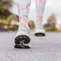 person in white and black nike shoes